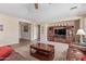 Comfortable living room with carpet and neutral walls, leading to other rooms at 15288 W Redfield Rd, Surprise, AZ 85379