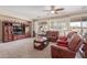 Living room featuring carpet, shutters, ceiling fan, and comfortable seating at 15288 W Redfield Rd, Surprise, AZ 85379