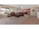 Inviting living room with carpet, ceiling fan, and view to a kitchen and backyard at 15288 W Redfield Rd, Surprise, AZ 85379