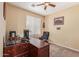 Office features a wooden desk, office chair, carpet, blinds, and bright walls at 15288 W Redfield Rd, Surprise, AZ 85379