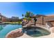 Backyard featuring a custom pool with rock waterfall and a relaxing in-ground hot tub at 15288 W Redfield Rd, Surprise, AZ 85379