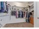 Organized walk-in closet with built-in shelving, clothing racks, and ample storage space at 15288 W Redfield Rd, Surprise, AZ 85379