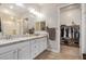 Bathroom featuring double sinks, granite counters, and a walk-in closet at 15550 S 5Th Ave # 130, Phoenix, AZ 85045