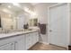 Bathroom featuring double sinks, granite counters, and a shower with glass door at 15550 S 5Th Ave # 130, Phoenix, AZ 85045