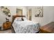 Comfortable bedroom with neutral walls, decor, and a gray and white patterned quilt at 15550 S 5Th Ave # 130, Phoenix, AZ 85045
