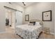 Bedroom featuring a white sliding barn door and neutral color scheme at 15550 S 5Th Ave # 130, Phoenix, AZ 85045