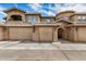 Charming townhouse showcasing a two-car garage, neutral stucco exterior, and well-maintained landscaping at 15550 S 5Th Ave # 130, Phoenix, AZ 85045