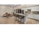 Modern kitchen with granite island, stainless steel appliances, seamlessly flows into the inviting living area at 15550 S 5Th Ave # 130, Phoenix, AZ 85045