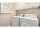 Bright laundry room featuring a washer, dryer and white cabinets at 15550 S 5Th Ave # 130, Phoenix, AZ 85045