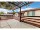 Inviting backyard patio with a wooden pergola providing shade and style, perfect for outdoor enjoyment at 16183 W Devonshire Ave, Goodyear, AZ 85395