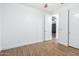 Open bedroom with neutral paint, wood-look floors, and ample closet space and natural light at 16183 W Devonshire Ave, Goodyear, AZ 85395
