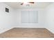 Empty bedroom featuring natural light, ceiling fan, and minimalist design at 16183 W Devonshire Ave, Goodyear, AZ 85395