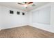 Empty bedroom showcasing flooring, ample natural light, and a ceiling fan at 16183 W Devonshire Ave, Goodyear, AZ 85395