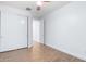 Neutral-painted bedroom with wood-look floors and sliding-door closet at 16183 W Devonshire Ave, Goodyear, AZ 85395