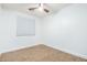 Simple bedroom offering neutral walls, wood-look flooring, and a fan to keep cool at 16183 W Devonshire Ave, Goodyear, AZ 85395
