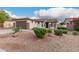 Single-story home featuring a desert landscape, two car garage, and well-maintained shrubs at 16183 W Devonshire Ave, Goodyear, AZ 85395