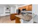 Bright kitchen featuring granite countertops, stainless steel appliances, and central island at 16183 W Devonshire Ave, Goodyear, AZ 85395