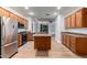Spacious kitchen with wood cabinets, stainless steel appliances, and a convenient center island at 16183 W Devonshire Ave, Goodyear, AZ 85395