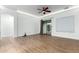 Spacious living room featuring hardwood floors, a ceiling fan, and a sliding glass door at 16183 W Devonshire Ave, Goodyear, AZ 85395