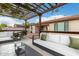 Outdoor patio featuring comfortable lounge seating under a beautiful wood pergola at 16183 W Devonshire Ave, Goodyear, AZ 85395