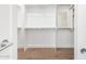 Spacious walk-in closet with custom shelving and rods, offering plenty of storage space at 16183 W Devonshire Ave, Goodyear, AZ 85395