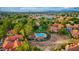 Aerial view showcasing a beautiful lake and community pool among verdant trees and red-tiled roofs at 1633 E Lakeside Dr # 98, Gilbert, AZ 85234