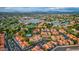 Stunning aerial view of the property with lake, tennis courts, pool and surrounding neighborhood and mountain views at 1633 E Lakeside Dr # 98, Gilbert, AZ 85234