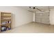 Clean, empty garage with shelving and an epoxy floor, providing ample storage and parking space at 1633 E Lakeside Dr # 98, Gilbert, AZ 85234