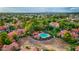 Aerial view of community pool surrounded by lush landscaping and red-tiled roofed homes at 1633 E Lakeside Dr # 98, Gilbert, AZ 85234