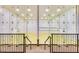 Indoor racquetball court featuring wood flooring, glass walls and railing with stairs at 1633 E Lakeside Dr # 98, Gilbert, AZ 85234