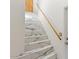 Elegant staircase with white marble-look tile and wooden handrail leading to the upper level at 1633 E Lakeside Dr # 98, Gilbert, AZ 85234