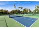 Multiple tennis courts with trees surrounding them are available on a clear, sunny day at 1633 E Lakeside Dr # 98, Gilbert, AZ 85234