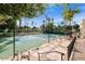 Tennis courts, palm trees, and green landscaping are viewed from an elevated seating area at 1633 E Lakeside Dr # 98, Gilbert, AZ 85234