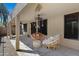 Comfortable seating arrangement on covered back patio with stylish rug and decor at 1650 S Crismon Rd # 86, Mesa, AZ 85209