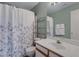 This bathroom with combined shower-over-tub with a floral curtain features a modern vanity at 1650 S Crismon Rd # 86, Mesa, AZ 85209