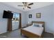 Well-lit bedroom with ceiling fan, neutral carpet, and lovely view from the picture window at 1650 S Crismon Rd # 86, Mesa, AZ 85209