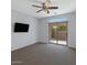 Bedroom featuring neutral carpet, ceiling fan, and large sliding door to the backyard at 1650 S Crismon Rd # 86, Mesa, AZ 85209