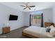 Cozy bedroom with a ceiling fan, neutral carpet, and picture window for natural light at 1650 S Crismon Rd # 86, Mesa, AZ 85209
