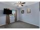 Neutral bedroom with window, ceiling fan, and a mounted television at 1650 S Crismon Rd # 86, Mesa, AZ 85209