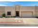 Inviting tan stucco home featuring a two-car garage, desert landscaping, and a charming front entrance at 1650 S Crismon Rd # 86, Mesa, AZ 85209