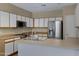 Functional kitchen equipped with stainless steel appliances, white cabinetry, and a practical peninsula design at 1650 S Crismon Rd # 86, Mesa, AZ 85209