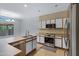 Well-lit kitchen with white cabinets, stainless steel appliances, and easy access to an outdoor space at 1650 S Crismon Rd # 86, Mesa, AZ 85209