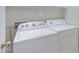 Convenient laundry area featuring a side-by-side washer and dryer, with upper storage at 1650 S Crismon Rd # 86, Mesa, AZ 85209