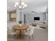 Bright open-concept living room with a modern chandelier and lots of natural light at 1650 S Crismon Rd # 86, Mesa, AZ 85209