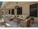 Covered patio featuring comfortable seating, stylish light fixture, and decorative area rug at 1650 S Crismon Rd # 86, Mesa, AZ 85209