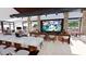 Relaxing lounge with comfortable seating, a large TV screen, and a counter, ideal for socializing and entertainment at 16689 W Hackamore Dr, Surprise, AZ 85387