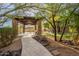 Beautiful backyard featuring a stone pathway leading to an outdoor kitchen and a covered seating area at 16716 S 32Nd Ln, Phoenix, AZ 85045