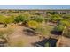 Large, undeveloped backyard surrounded by mature trees and desert landscape, offering privacy and space at 16716 S 32Nd Ln, Phoenix, AZ 85045