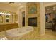 Elegant bathroom with soaking tub, fireplace, and granite finishes at 16716 S 32Nd Ln, Phoenix, AZ 85045