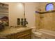 Bathroom with granite countertop, sink, tub, and decorative elements exudes elegance and functionality at 16716 S 32Nd Ln, Phoenix, AZ 85045